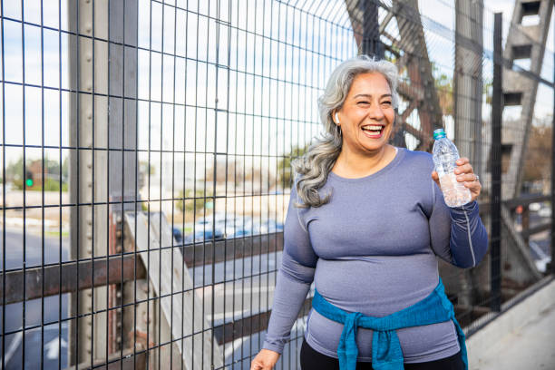 istock Senior Mexican Woman Drinking Water 1188763140