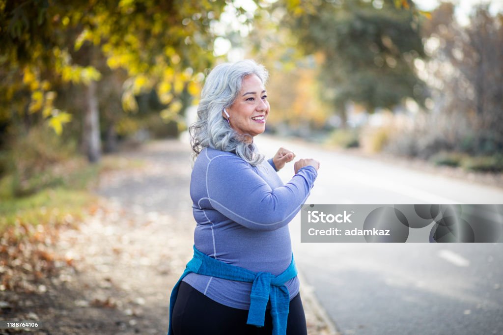 Mexican Woman Stretching Back A senior Mexican woman stretching her legs Yoga Stock Photo