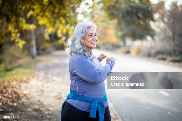 Mexican Woman Stretching Back Stock Photo - Download Image Now - Yoga, Senior Adult, Twisted