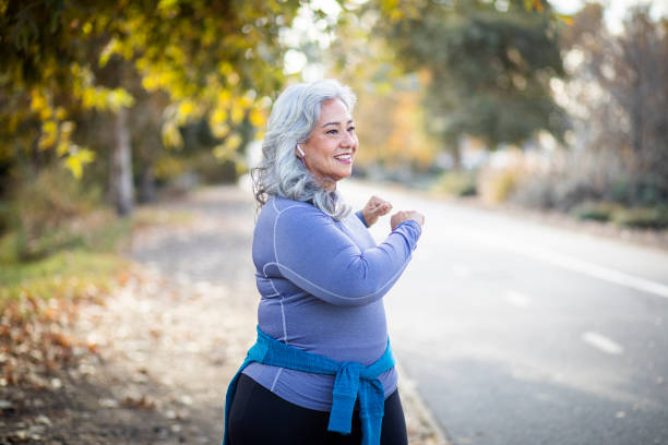 mexican woman stretching back - twisted tree california usa imagens e fotografias de stock