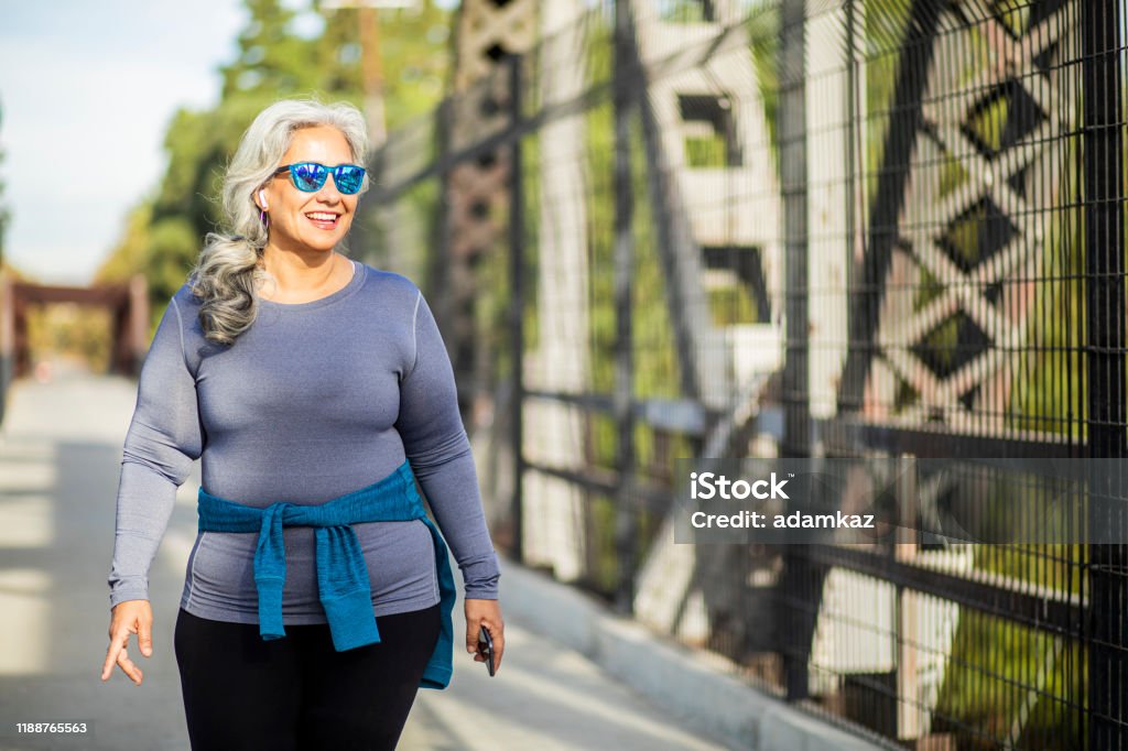 Mexican Woman Walking A portrait of a beautiful senior Mexican woman Walking Stock Photo