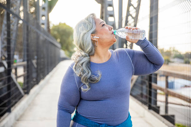 istock Senior Mexican Woman Drinking Water 1188765979