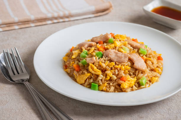 istock Fried rice chicken with egg and vegetables on white plate 1188766968