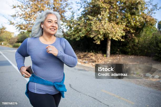 Mexican Woman Jogging Stock Photo - Download Image Now - Exercising, Running, Senior Adult