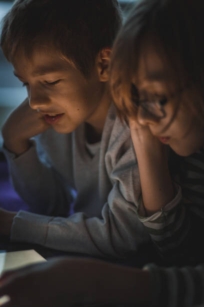 istock Teenage boys having fun while relaxing and using digital tablet together 1188768361