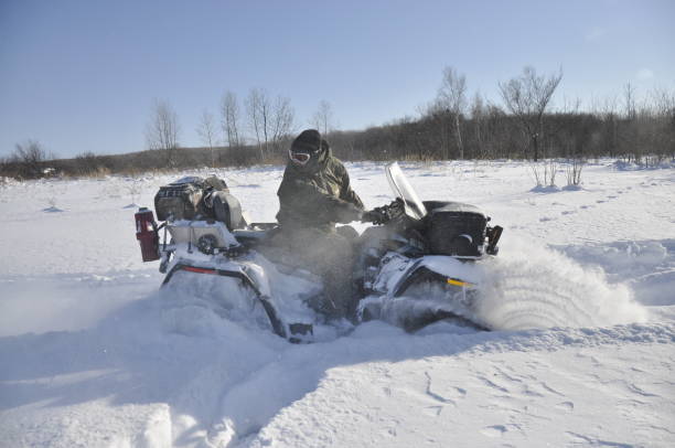 istock ATV on tracks ride back in a deep snow in the taiga. 1188769763