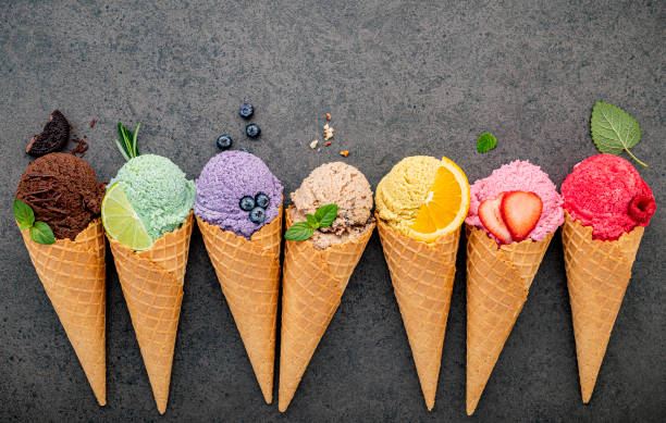 istock Flat lay ice cream cones collection on dark stone background . Blank crispy ice cream cone with copy space for sweets menu design. 1188771359