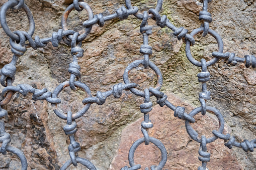 Close up iron chain rings in front of Stonewall