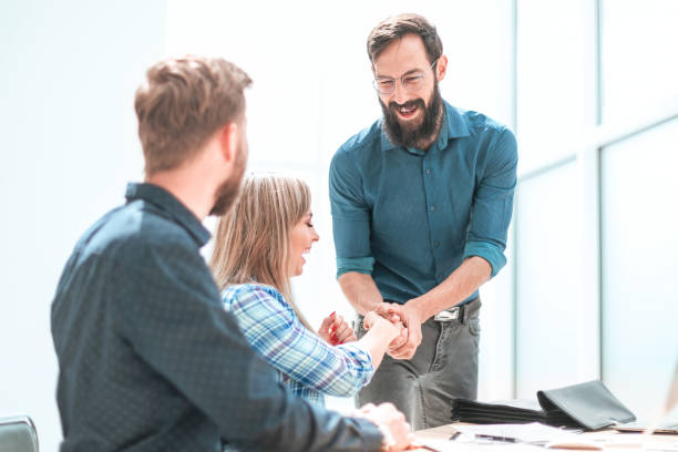 istock happy project Manager shaking hands with employee. 1188777608