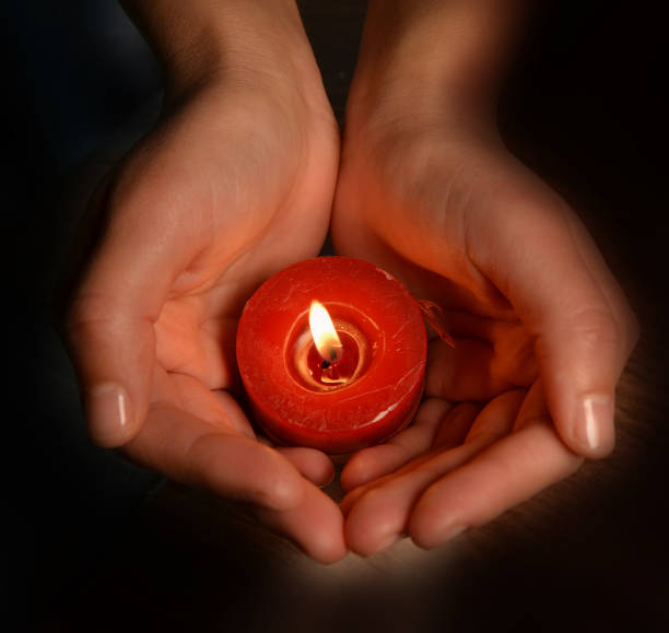 istock candles lighting on a hand xmas background holidays red in the night 1188782661