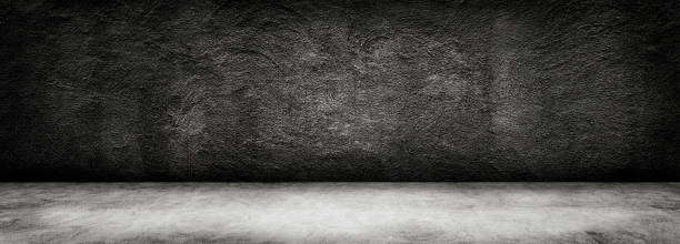 istock Studio dark room black concrete grunge wall with concrete floor. 1188786549