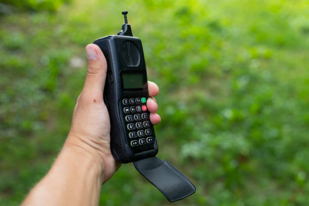 Classic mobile phone from the early 2000s with white screen isolated on white background.