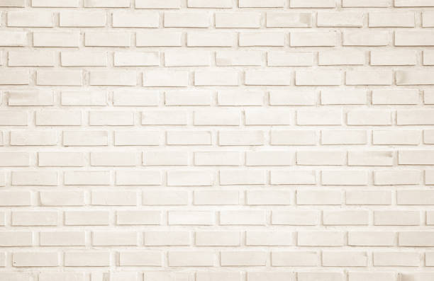 istock Wall cream brick wall texture background in room at subway. Brickwork stonework interior, rock old clean concrete grid uneven abstract weathered bricks tile design, horizontal architecture wallpaper. 1188792055