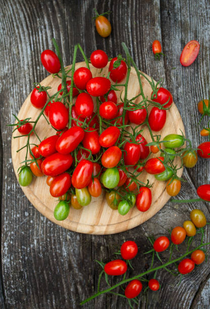 istock round cutting board and tomatoes on wooden surface 1188799274