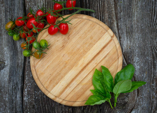 istock round cutting board and tomatoes on wooden surface 1188799285
