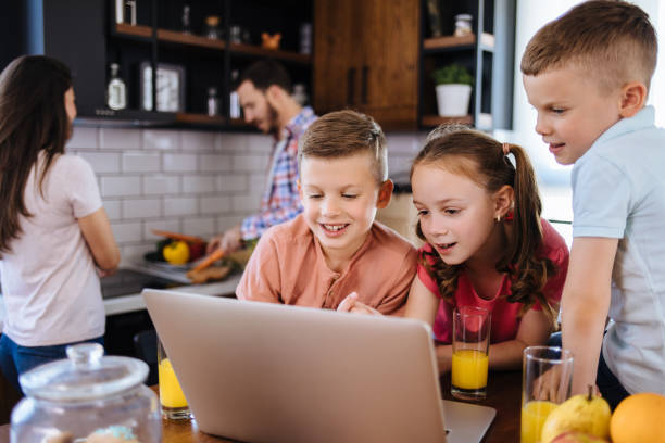 istock Children surfing the internet using laptop while having breakfast at home 1188803655
