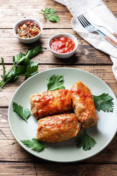 istock Cabbage rolls with beef, rice and vegetables on the plate. Stuffed cabbage leaves with meat. Wooden background. 1188803700