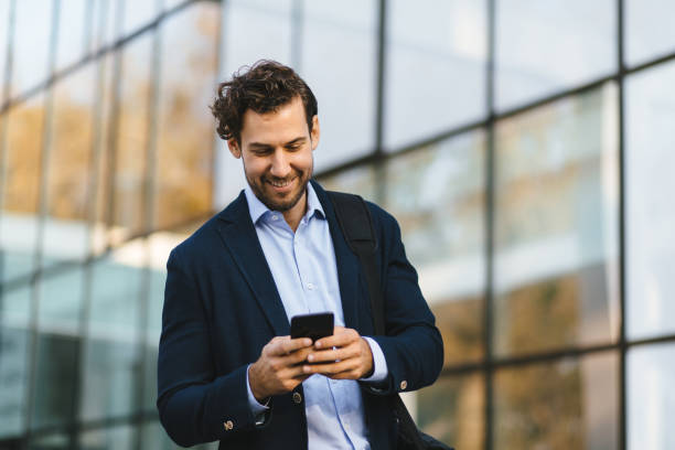 istock Young businessman typing text message on his way to work 1188803808