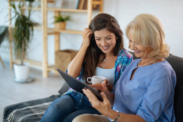 istock Senior mother and daughter browsing internet on tablet 1188804839