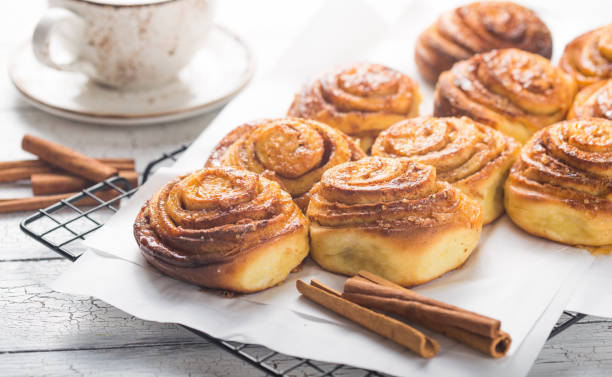 istock Latte or cacao and Cinnamon Bun for breakfast or break on white background. Cup of coffee and homemade buns 1188805802