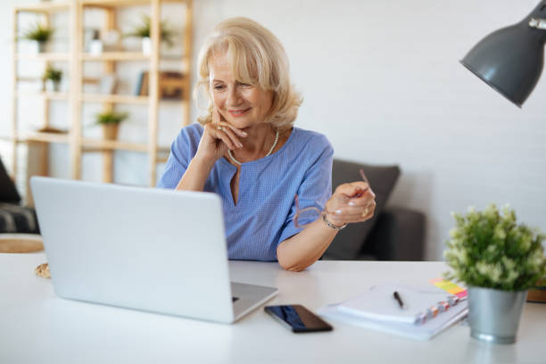 istock Senior woman using laptop at home 1188805892