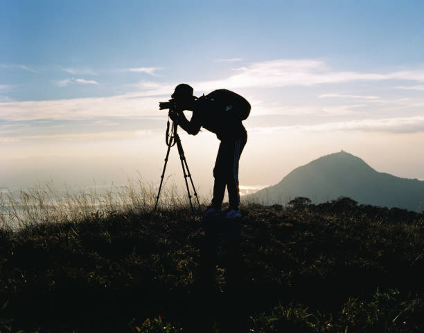 istock Blur man silhouette taking photo on sunset time at mountain (120 Film scan photo) 1188821733