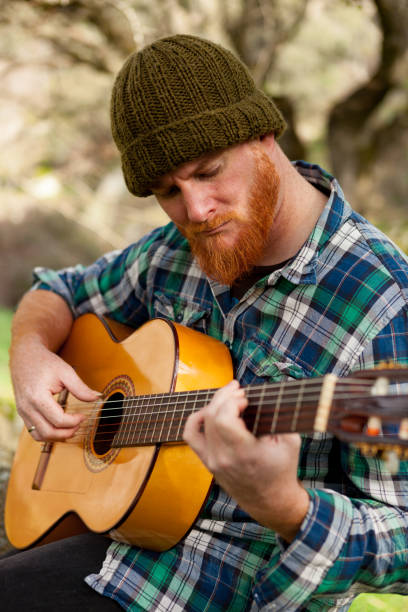 istock Hipster man with red beard playing a guitar 1188822218