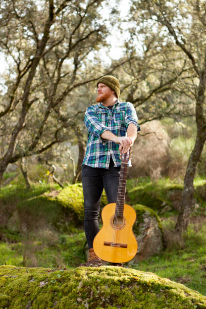 istock Hipster man with red beard and a guitar relaxs 1188822284