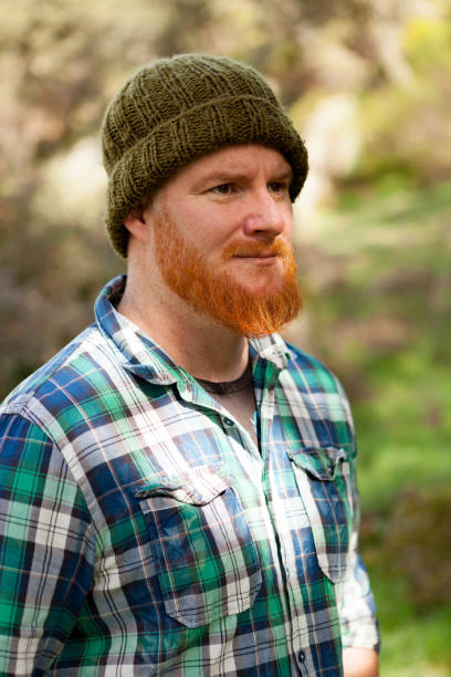 istock Portrait of a hipster guy thinking in the forest 1188822290