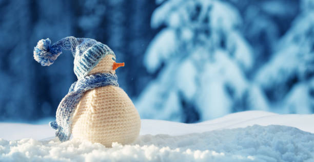 istock little snowman on soft snow on blue background 1188823172
