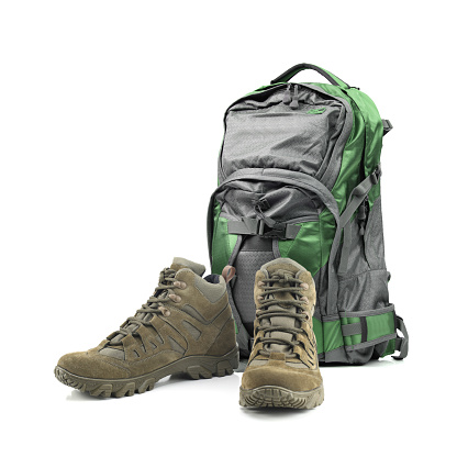 Backpack and hiking boots isolated on white background