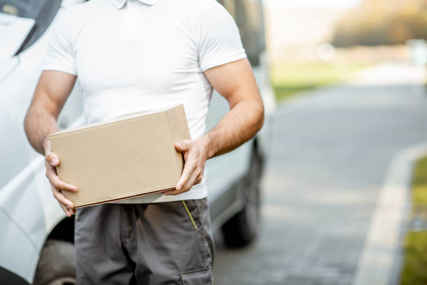 istock Delivery man with parcel outdoors 1188824778