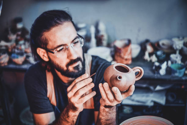 istock Talented artist at his own pottery studio is workig for new project. 1188826186