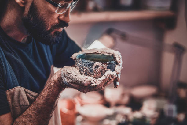 istock Photoshoot of working process with clay by diligent man. 1188826473