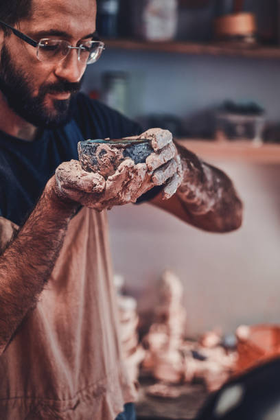 istock Hrdworking man with clay at his own studio. 1188828106