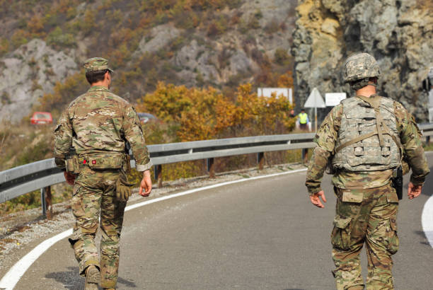 Kosovo; Jarinje crossing; October 25th; Back of two American NATO soldier. stock photo