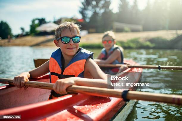 Two Boys Enjoying Kayaking On Lake Stock Photo - Download Image Now - Summer Camp, Child, Family