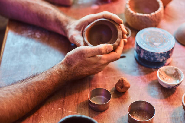 istock Closeup of working process with clay by diligent man. 1188829305