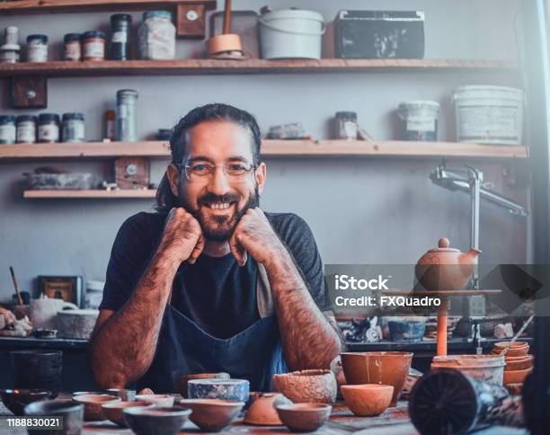Charismatic Man In Glasses Is Sitting At His Owh Workshop And His Projects Are Around Him Stock Photo - Download Image Now