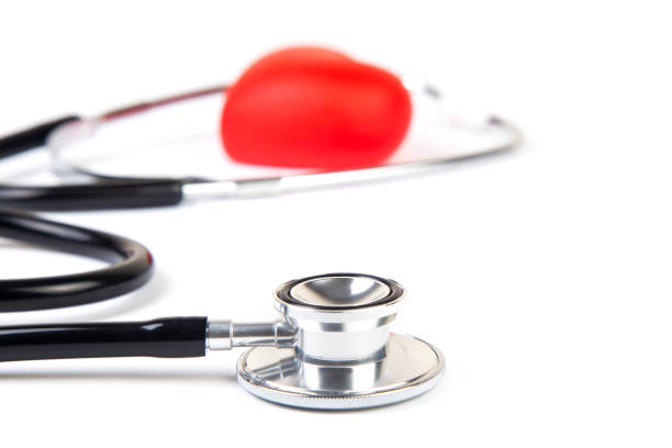 Black stethoscope and red heart isolated on white background