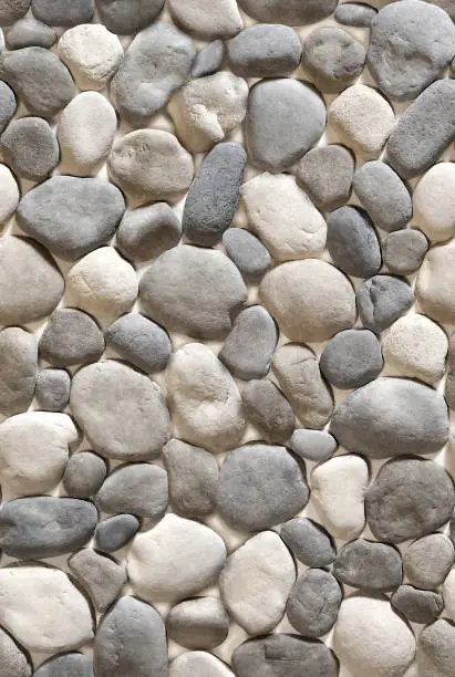 Decorative overlay stone in the form of gray and black cobblestones .Texture or background.