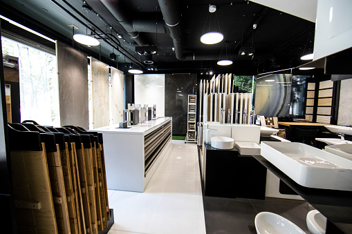A toilet and bathroom equipment store with toilet bowls, sinks and faucets on display.