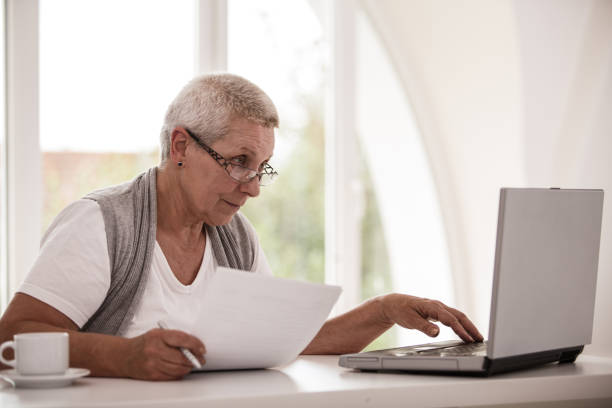 istock Senior woman checking her pension on her laptop 1188842519