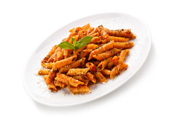 istock Penne with pork, sauce and vegetables on white background 1188842903