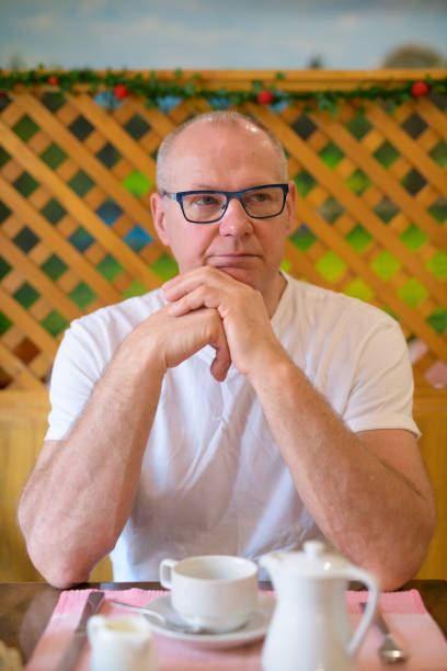 istock Senior man thinking and sitting at restaurant ready for breakfast 1188844285