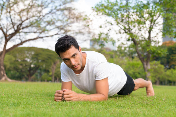 istock Young handsome Hispanic man doing plank exercise outdoors 1188845623