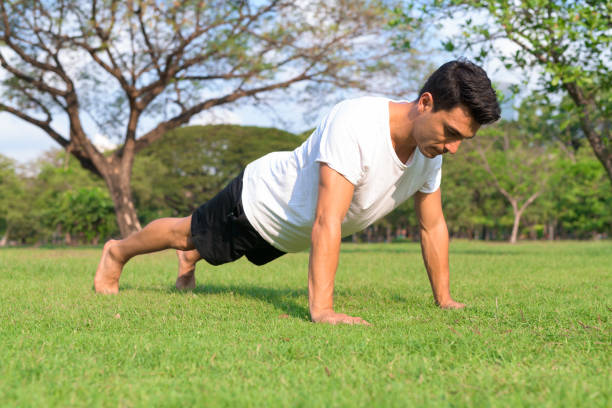 istock Young handsome Hispanic man doing push up in the park outdoors 1188845644