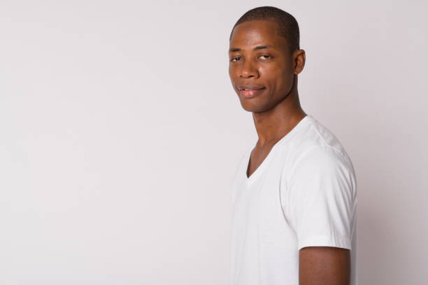 istock Closeup profile view of young handsome bald African man looking at camera 1188846997