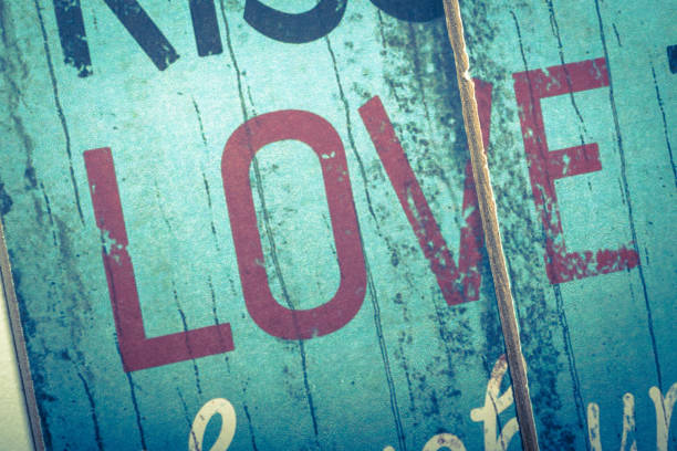 Love word printed on vintage wooden board. Calligraphy script love text.