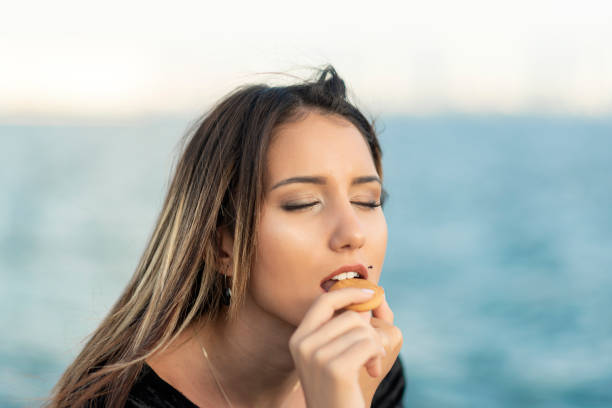 istock Happy girl eating a cookie 1188850386